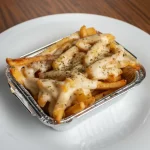 Porción de papas gratinadas Muzza