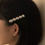 Hair clip de bolitas dorado